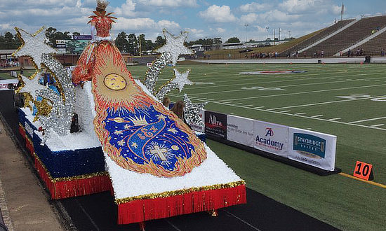 Texas Rose Festival parade float entering the Rose Stadium